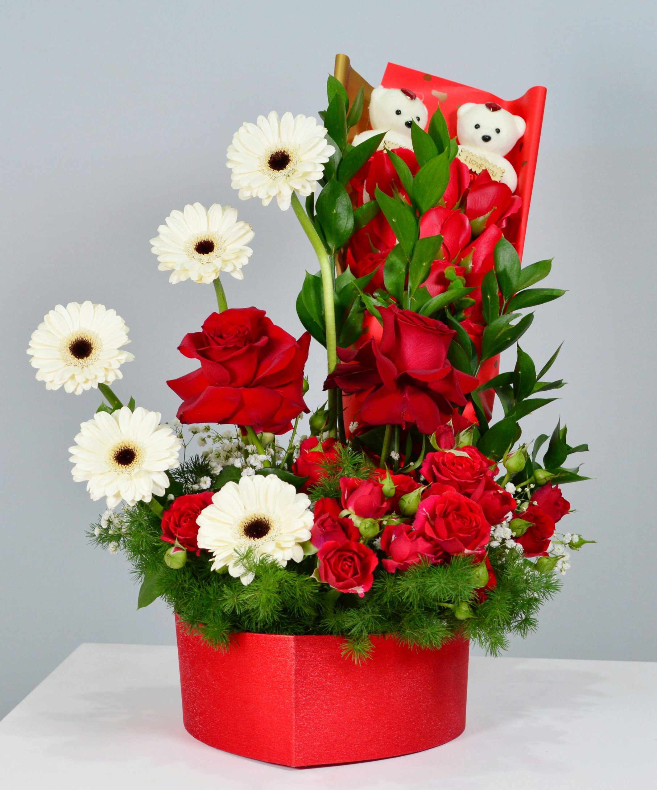 Red and white flower bouquet with teddy bears, perfect for gifts in Dubai.